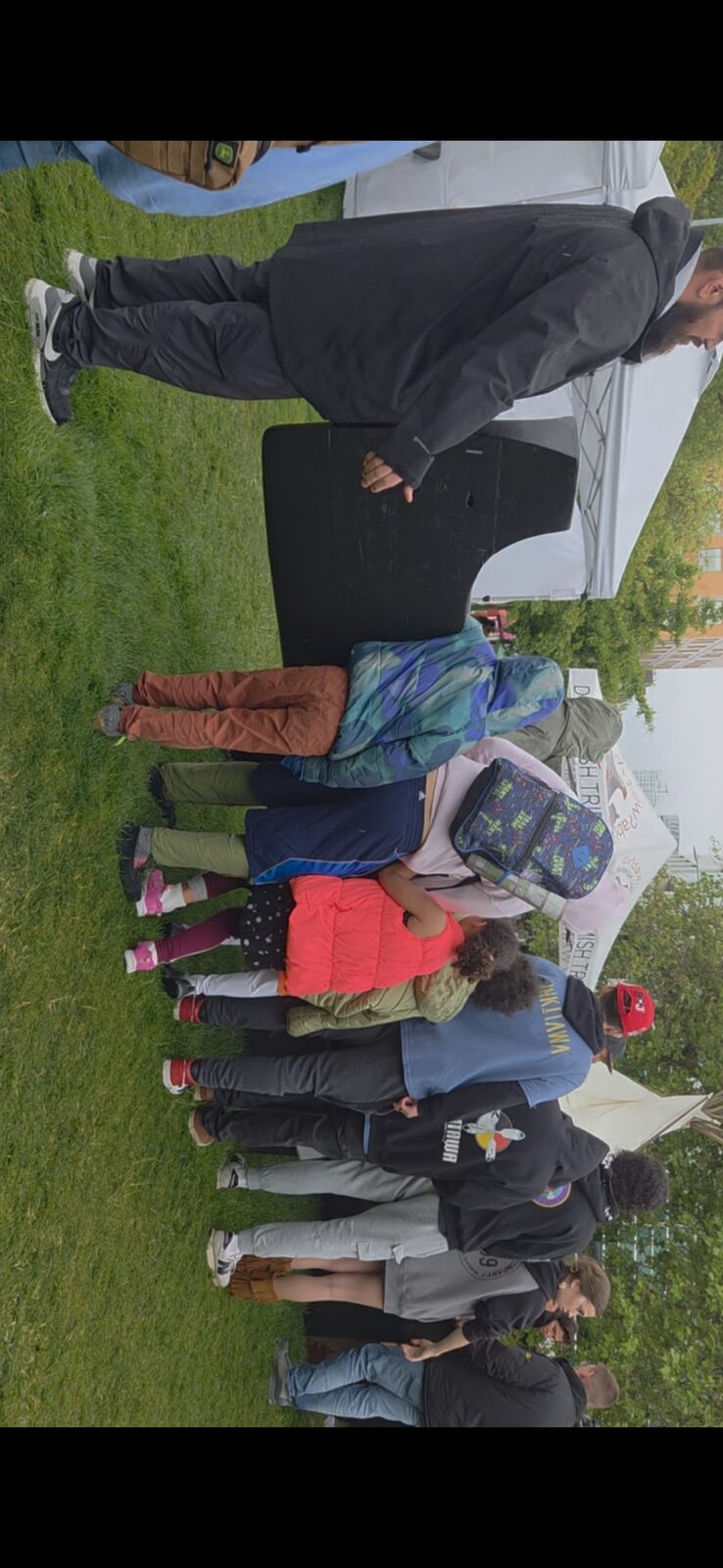 Youth gathered around the Duwamish canoe at NW Folklife