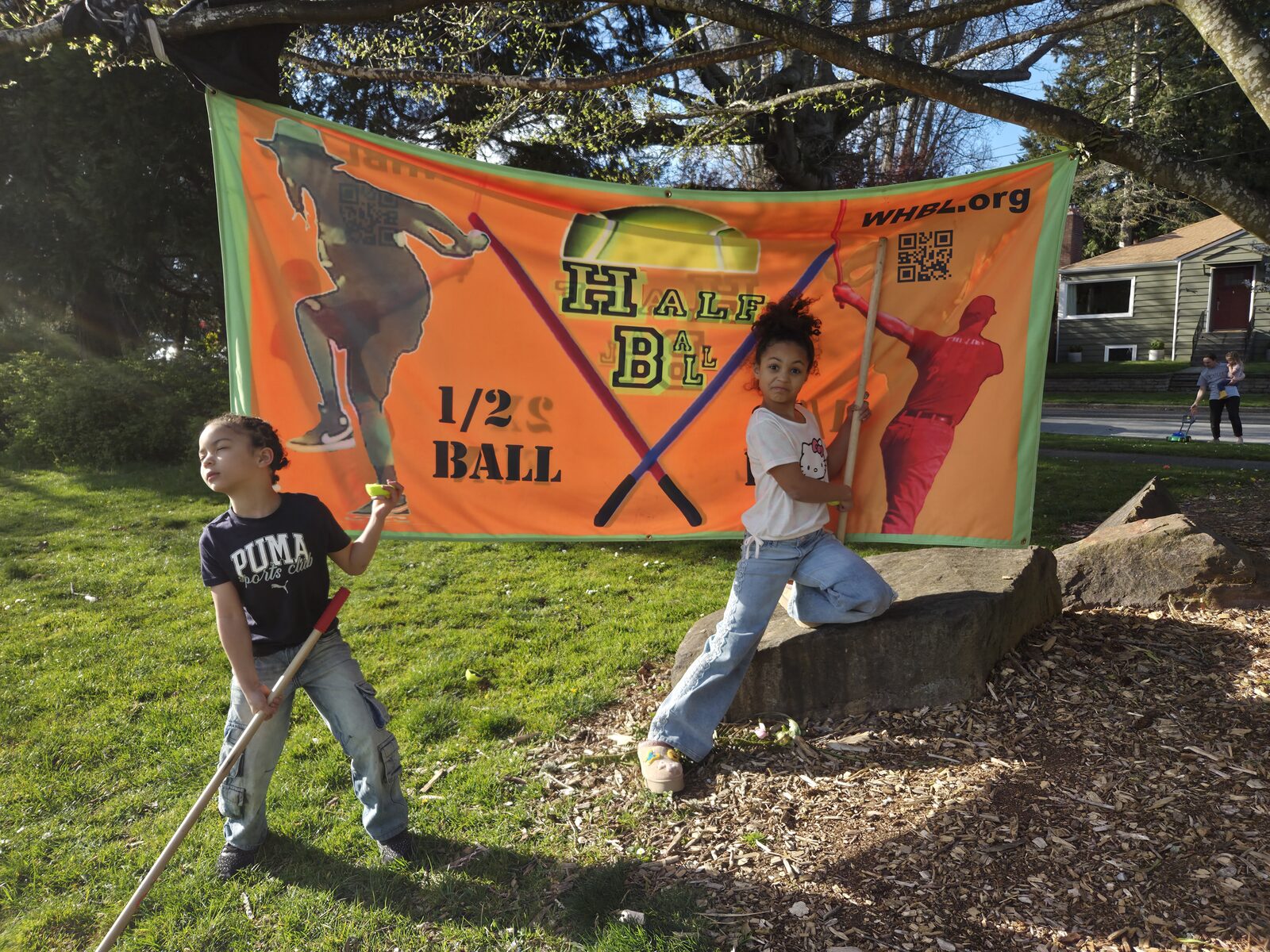 Two children with the HalfBall League banner at a Seattle park