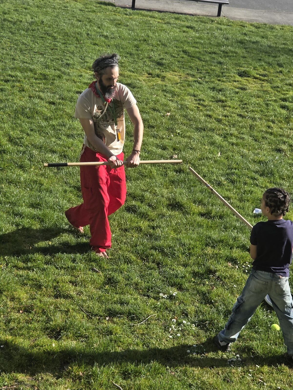 Cody and a young rep with staves on the grass